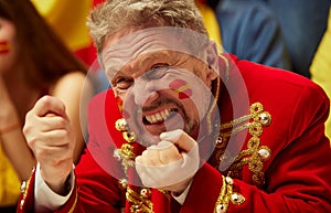 Close-up image of man, football, soccer fans emotionally watching match, worrying about favourite team. Fans wearing