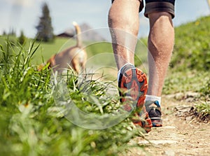 Close-up image of a men's legs during the mountain walk