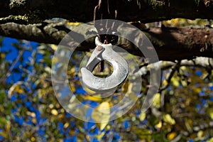 Metal Hook Hanging from Rusty Chain Outdoors
