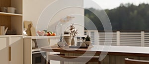 A close-up image of a modern minimal wooden kitchen island in a contemporary white kitchen