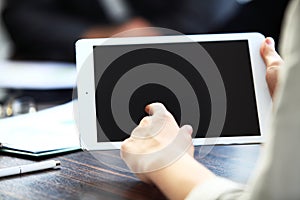 Close-up image of an office worker using a touchpad to analyze