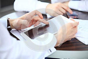 Close-up image of an office worker using a touchpad to analyze