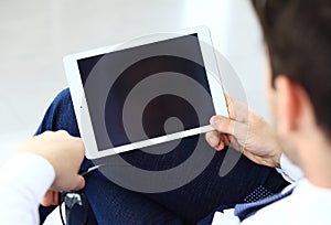 Close-up image of an office worker using a touchpad to analyze