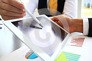 Close-up image of an office worker using a touchpad to analyze