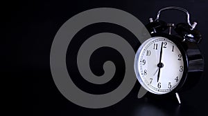 Close up image of old black vintage alarm clock. Six o`clock