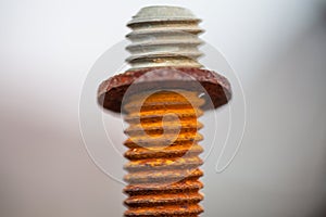 Close-up image of old rusty and bolt on steel surface with blurred background