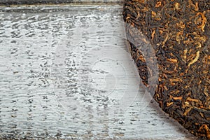 Close up image old Shu puerh chinese fermented tea on rustic wooden background