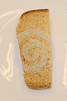 Close-up image of one slice of white bread against the white background .