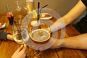 Close up image of peope toasting with glasses of red wine in the restoran.