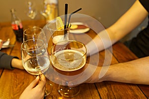 Close up image of peope toasting with glasses of red wine in the restoran. photo