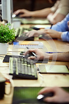 Close-up image of people& x27;s hands, graphic designers and retouchers working with keyboard and graphic tablets