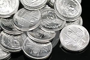 A pile of Pakistani one rupee coins in macro