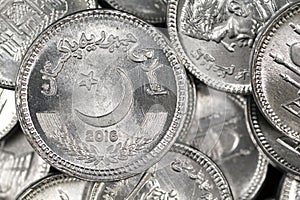 A pile of Pakistani one rupee coins in macro