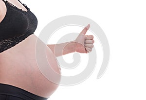 Close up image of pregnant woman with her hand and shows thumb up