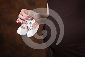 Close-up Image of pregnant woman touching her belly with hands