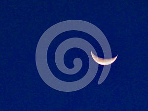 Close up image of quarter moon against the backdrop of day sky .