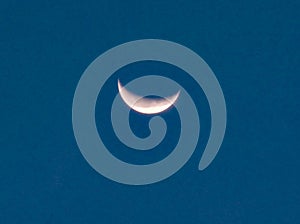 Close up image of quarter moon against the backdrop of day sky .