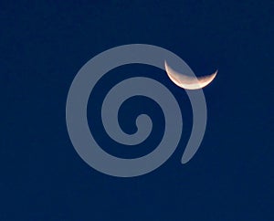 Close up image of quarter moon against the backdrop of day sky .