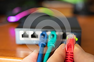 Close-up image of a router: the connections of the three red, green and blue ethernet cables are tested. Concept of cabling,