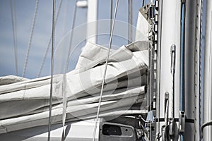 Close up image of sail and mast pulley systm on yacht sailboat