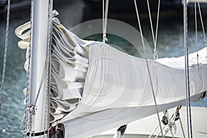 Close up image of sail and mast pulley systm on yacht sailboat