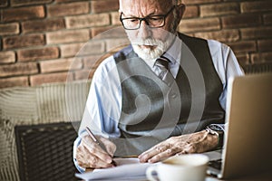 Close up image of senior businessmen working at his office.