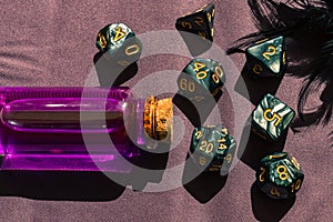 Close-up image of a set of rpg dice and a pink potion