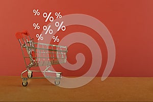 A close-up image of a shopping cart and a discounted price highlighted with a percentage off, showcasing the convenience and