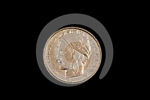 An old Italian lira coin shot against a black background