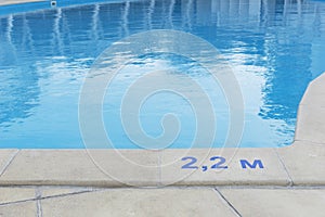 close up image of signs of depth in meters in swimming pool