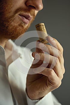 Close up image of sommelier examining smell of wine cork