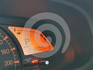 Close up image of a speedometer in a car.