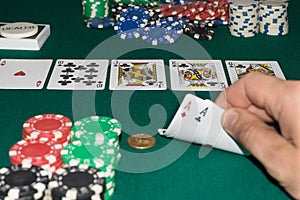 A close up image of stacked poker chips and a royal flush. A textured background.Copy paste place