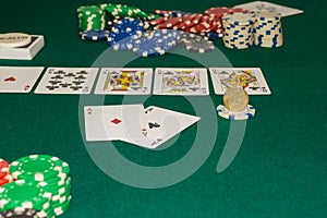 A close up image of stacked poker chips and a royal flush. A textured background.Copy paste place