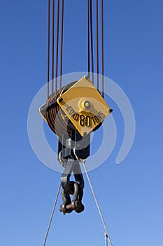 Close up image of a steel cable pulley on a crane