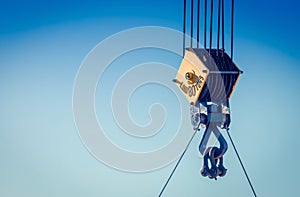 Close up image of a steel cable pulley on a crane