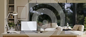 Close-up image of study table in modern contemporary living room with laptop mockup