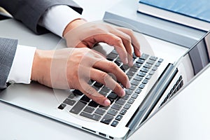 Close-up image of typing male hands