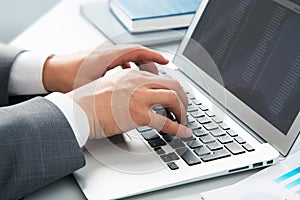 Close-up image of typing male hands