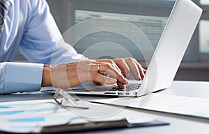 Close-up image of typing male hands