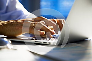 Close-up image of typing male hands