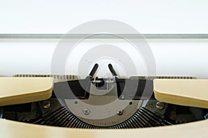 Close up image of vintage typewriter with white paper sheet. Copy space for your text. Retro filtered