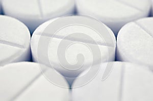 Close-up image of white pills. Macro with extremely shallow depth of field