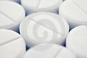 Close-up image of white pills. Macro with extremely shallow depth of field