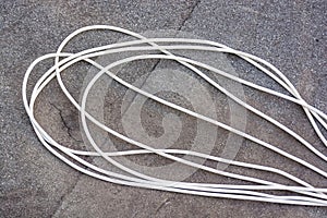 Closeup white electrical cable on ground