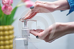 Close up image of woman applying sanitizer gel. Cleaning, washing hands with alcohol-based hand sanitizer liquid, using