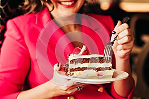 Close up image of woman eating cake