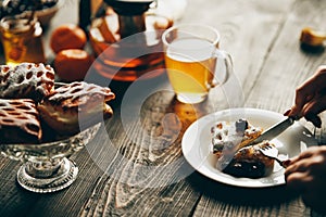 Close up image of a woman eating cherry pastries with fork and knif in cafe