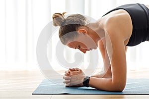 Close up image of yoga woman holding elbow plank pose on the mat