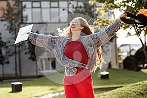 Close-up image of young blonde woman student celebrate success after exams in university.